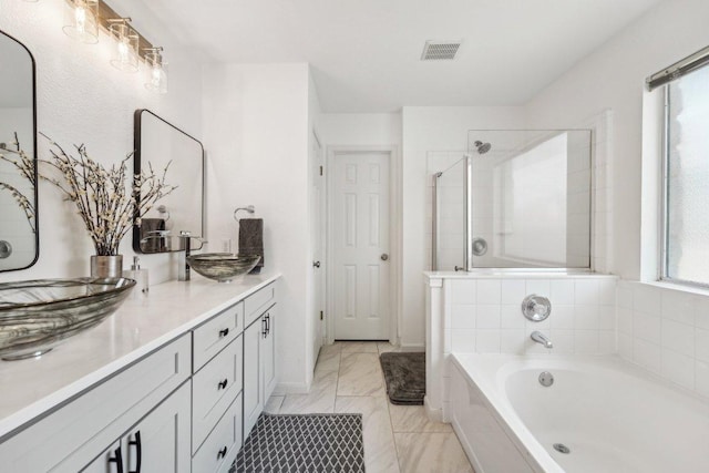 6015 Lone Star Ct, Hutto, TX 78634 - full bathroom with a garden tub, double vanity, marble finish floors, and tiled shower