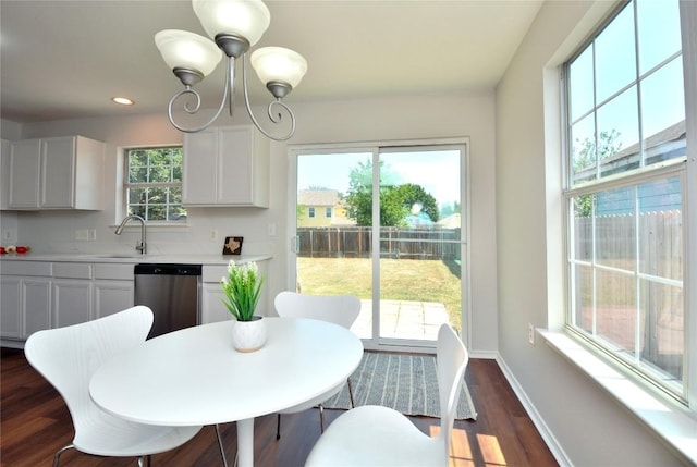 1902 Tranquilo Trl, Austin, TX 78744 - dining space with dark wood finished floors, a chandelier, baseboards, and recessed lighting
