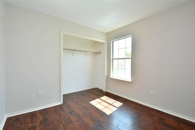 1902 Tranquilo Trl, Austin, TX 78744 - unfurnished bedroom featuring wood finished floors, a closet, and baseboards