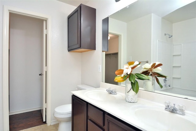 1902 Tranquilo Trl, Austin, TX 78744 - bathroom with double vanity, toilet, shower / bath combination, a closet, and tile patterned flooring