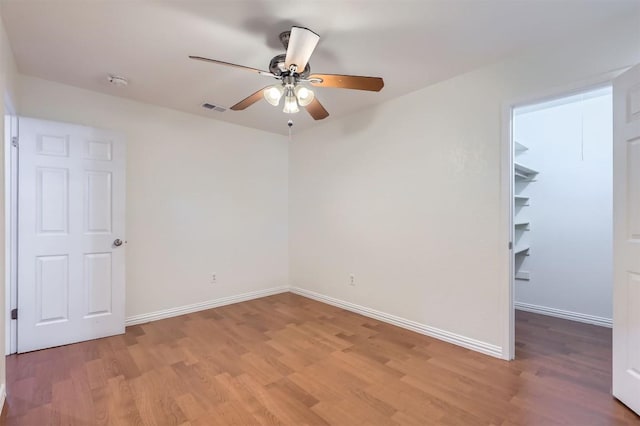 11619 Birchbark Trl, Austin, TX 78750 - empty room featuring light wood-type flooring, ceiling fan, and baseboards