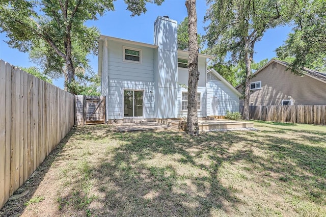 11619 Birchbark Trl, Austin, TX 78750 - back of property featuring a chimney and a patio area