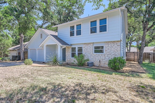 11619 Birchbark Trl, Austin, TX 78750 - view of front facade featuring stone siding, an attached garage, and concrete driveway