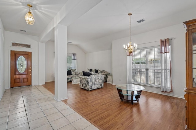15617 Staffordshire Ln, Austin, TX 78717 - entryway with plenty of natural light, light wood finished floors, lofted ceiling, and a chandelier