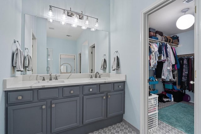 15617 Staffordshire Ln, Austin, TX 78717 - bathroom featuring tile patterned floors, double vanity, and a spacious closet