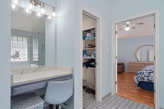 15617 Staffordshire Ln, Austin, TX 78717 - bathroom featuring tile patterned floors, a walk in closet, a ceiling fan, ensuite bathroom, and a shower