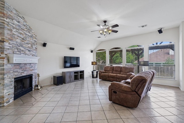 15617 Staffordshire Ln, Austin, TX 78717 - living area with light tile patterned floors, a stone fireplace, a ceiling fan, and lofted ceiling
