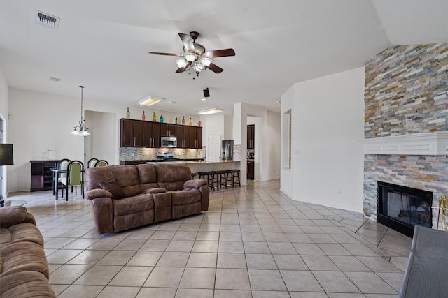 15617 Staffordshire Ln, Austin, TX 78717 - living area featuring ceiling fan, light tile patterned floors, and a fireplace