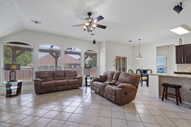 15617 Staffordshire Ln, Austin, TX 78717 - living room featuring light tile patterned floors, healthy amount of natural light, ceiling fan, lofted ceiling, and a chandelier