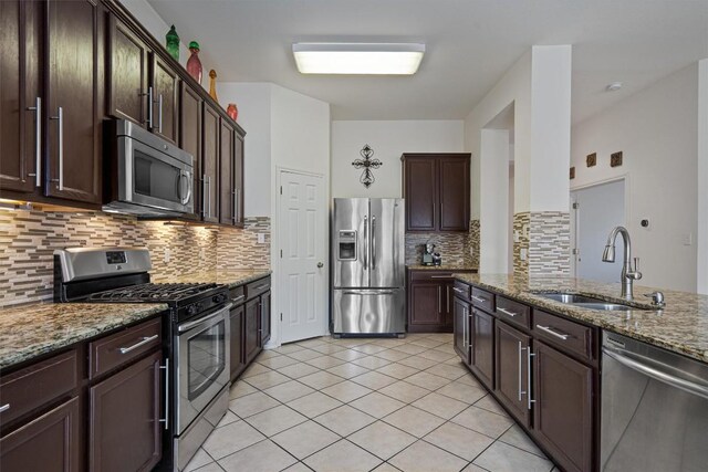 15617 Staffordshire Ln, Austin, TX 78717 - kitchen featuring stainless steel appliances, stone countertops, backsplash, and dark brown cabinetry