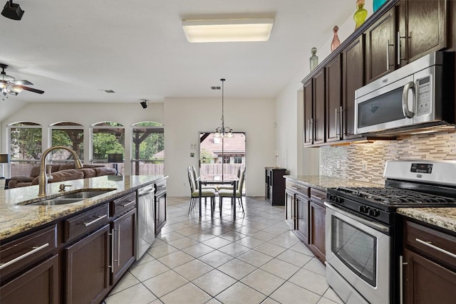 15617 Staffordshire Ln, Austin, TX 78717 - kitchen featuring stainless steel appliances, decorative backsplash, ceiling fan, dark brown cabinets, and open floor plan