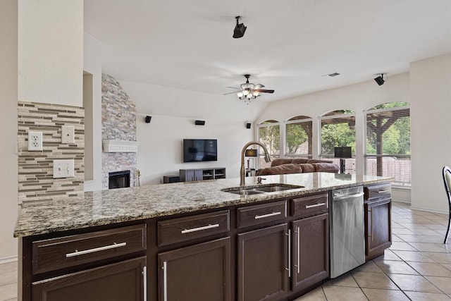 15617 Staffordshire Ln, Austin, TX 78717 - kitchen featuring open floor plan, a ceiling fan, dark brown cabinetry, light tile patterned floors, and stainless steel dishwasher