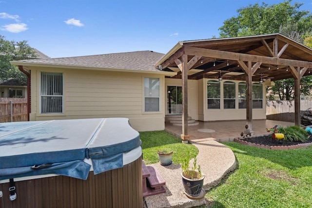 15617 Staffordshire Ln, Austin, TX 78717 - back of house with a hot tub, a shingled roof, and a patio area