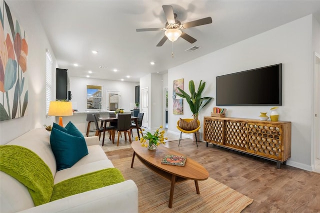 212 Canis St, Georgetown, TX 78628 - living area with light wood-type flooring, ceiling fan, baseboards, and recessed lighting