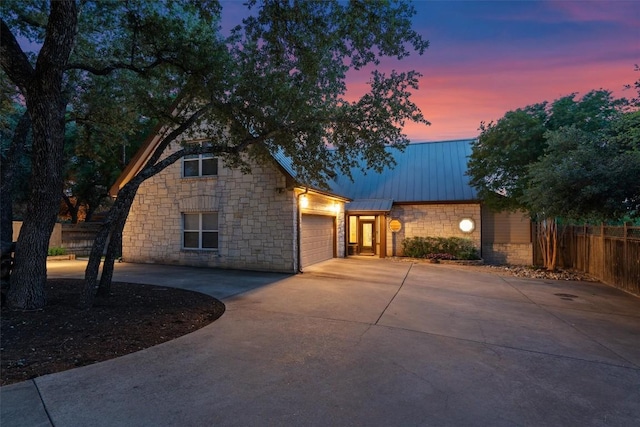 17505 E Darleen Dr, Leander, TX 78641 - view of front of home with stone siding, driveway, an attached garage, and metal roof