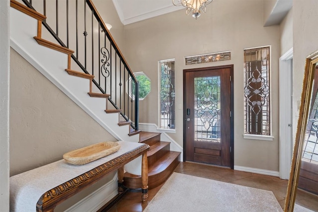 17505 E Darleen Dr, Leander, TX 78641 - foyer entrance with stairway, tile patterned flooring, baseboards, ornamental molding, and a high ceiling