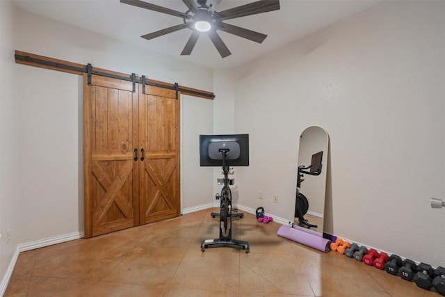 17505 E Darleen Dr, Leander, TX 78641 - workout room with a barn door, ceiling fan, tile patterned flooring, and baseboards