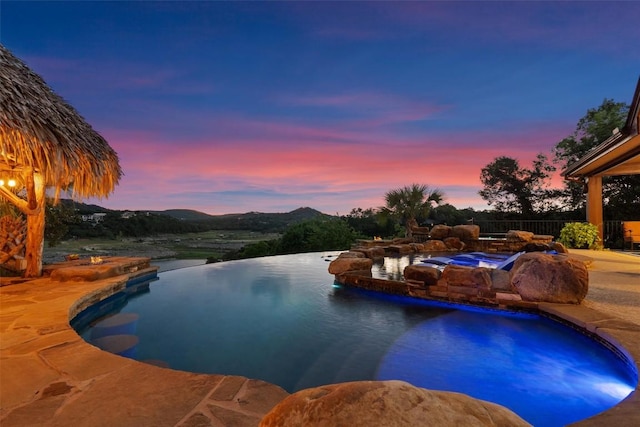 17505 E Darleen Dr, Leander, TX 78641 - pool at dusk with a pool with connected hot tub