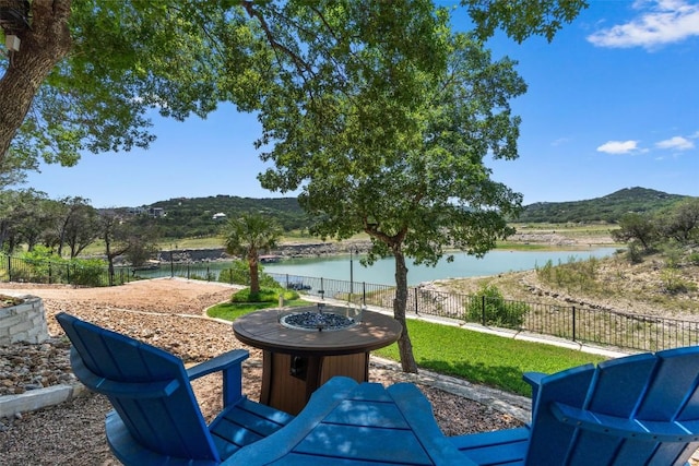 17505 E Darleen Dr, Leander, TX 78641 - fenced backyard with a water and mountain view and an outdoor fire pit