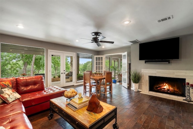 2924 Gabriel View Dr, Georgetown, TX 78628 - living area featuring french doors, wood finished floors, a fireplace, recessed lighting, and a ceiling fan