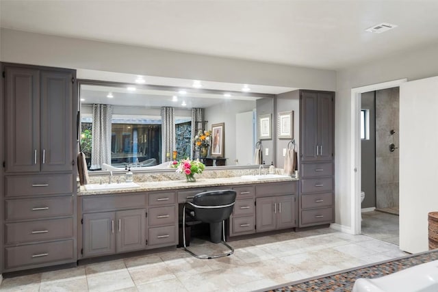 2924 Gabriel View Dr, Georgetown, TX 78628 - full bath with double vanity, toilet, healthy amount of natural light, and baseboards