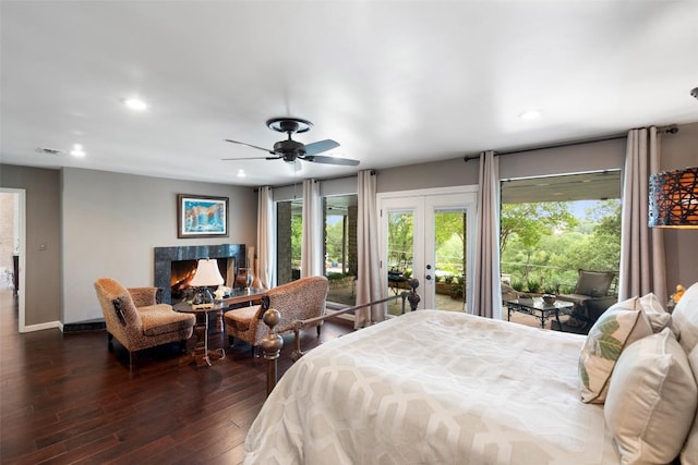 2924 Gabriel View Dr, Georgetown, TX 78628 - bedroom featuring french doors, access to outside, recessed lighting, dark wood-style flooring, and a high end fireplace