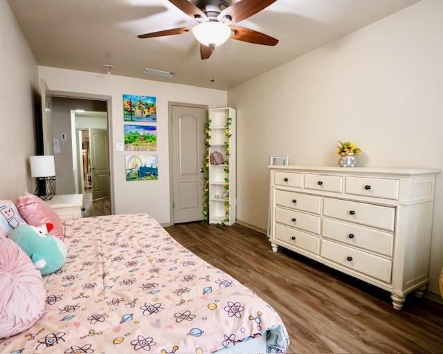 1406 Apache Cv, Pflugerville, TX 78660 - bedroom with dark wood finished floors and ceiling fan