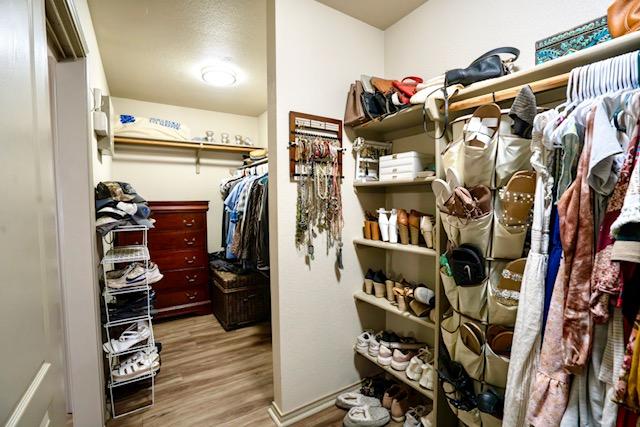 1406 Apache Cv, Pflugerville, TX 78660 - spacious closet featuring wood finished floors