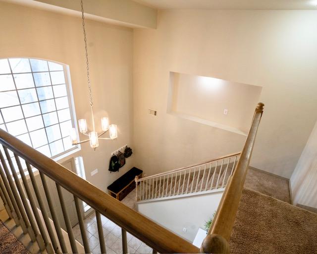1406 Apache Cv, Pflugerville, TX 78660 - stairs featuring a chandelier and carpet floors