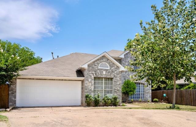 1406 Apache Cv, Pflugerville, TX 78660 - view of front of property featuring a garage, driveway, and stone siding