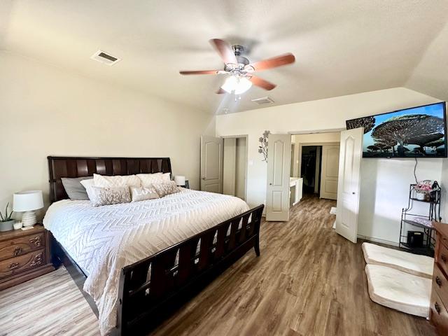 1406 Apache Cv, Pflugerville, TX 78660 - bedroom with wood finished floors, lofted ceiling, and a ceiling fan
