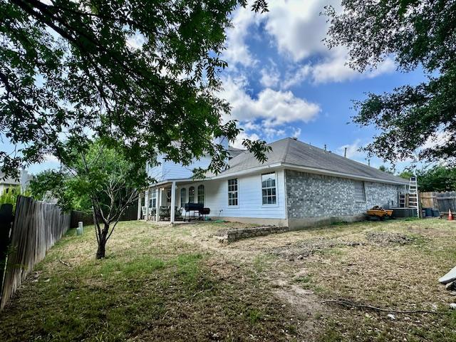 1406 Apache Cv, Pflugerville, TX 78660 - back of house featuring a fenced backyard and a patio