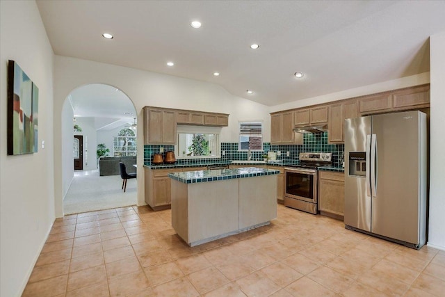 10902 Sierra Oaks, Austin, TX 78759 - kitchen with stainless steel appliances, under cabinet range hood, a center island, decorative backsplash, and lofted ceiling