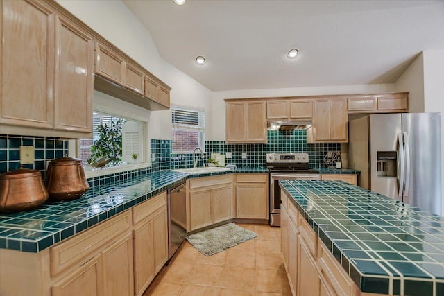 10902 Sierra Oaks, Austin, TX 78759 - kitchen with tile countertops, stainless steel appliances, a sink, light brown cabinetry, and decorative backsplash