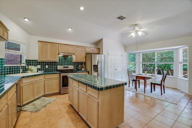 10902 Sierra Oaks, Austin, TX 78759 - kitchen with stainless steel appliances, tile countertops, a sink, light brown cabinets, and lofted ceiling
