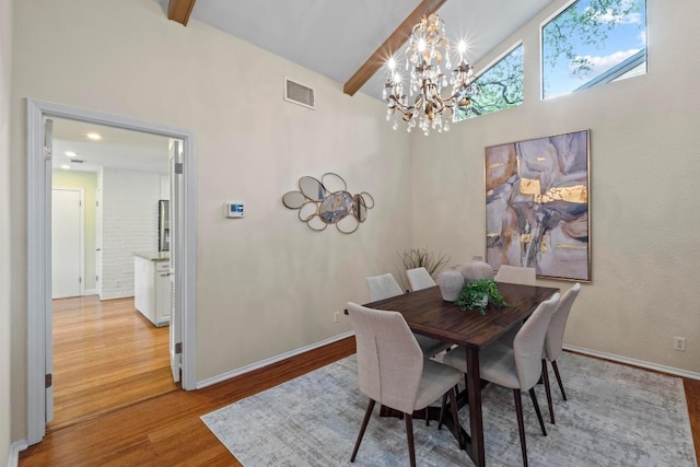 8126 Greenslope Dr, Austin, TX 78759 - dining space featuring a chandelier, beam ceiling, light wood-style flooring, baseboards, and high vaulted ceiling