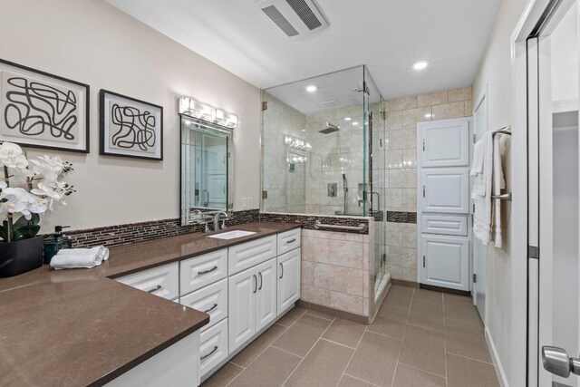 8126 Greenslope Dr, Austin, TX 78759 - bathroom with vanity, tile patterned flooring, a stall shower, and recessed lighting