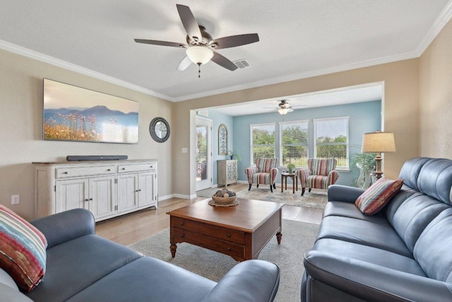 709 Kitty Hawk Rd, Georgetown, TX 78633 - living room featuring light wood finished floors, ornamental molding, a ceiling fan, and baseboards