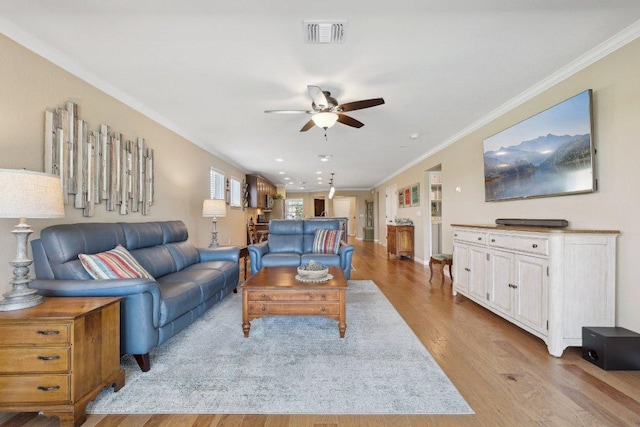 709 Kitty Hawk Rd, Georgetown, TX 78633 - living area featuring ceiling fan, light wood-style floors, and crown molding