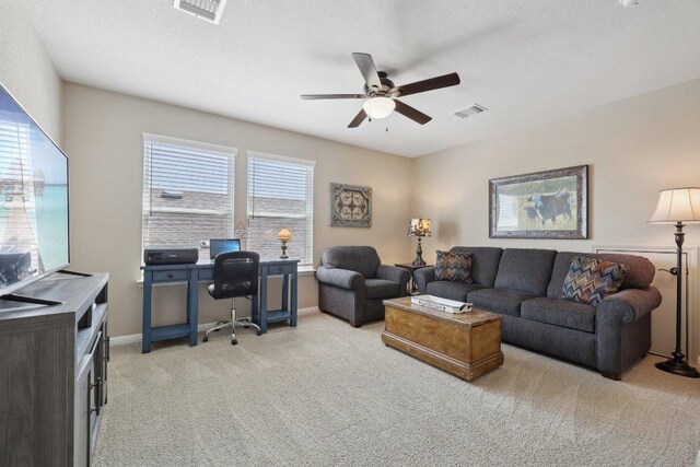 709 Kitty Hawk Rd, Georgetown, TX 78633 - living area featuring light carpet, ceiling fan, a desk, and baseboards