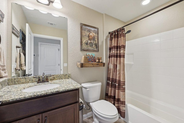 709 Kitty Hawk Rd, Georgetown, TX 78633 - bathroom featuring toilet, vanity, shower / bath combination with curtain, and a textured wall