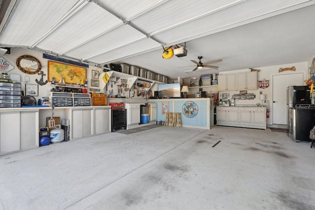 709 Kitty Hawk Rd, Georgetown, TX 78633 - garage with a garage door opener, a ceiling fan, and a workshop area