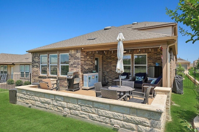 709 Kitty Hawk Rd, Georgetown, TX 78633 - back of house featuring outdoor lounge area, a patio area, brick siding, and roof with shingles