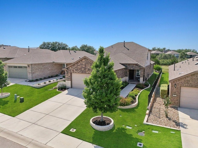 709 Kitty Hawk Rd, Georgetown, TX 78633 - view of front of house featuring driveway, a garage, a shingled roof, and a front yard