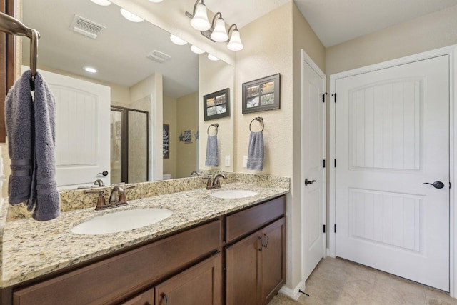 709 Kitty Hawk Rd, Georgetown, TX 78633 - full bath featuring a shower stall, double vanity, toilet, and tile patterned flooring