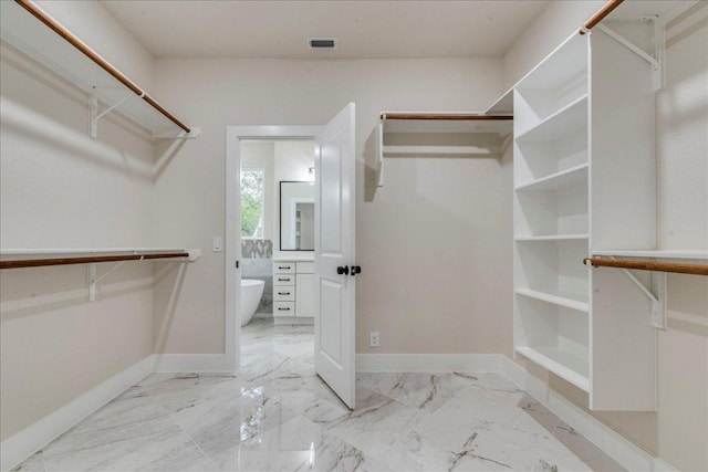 2 Basswood Cir, Wimberley, TX 78676 - walk in closet featuring marble look tiles