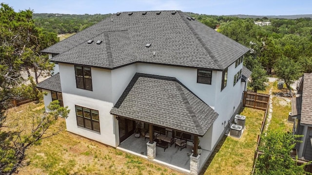 2 Basswood Cir, Wimberley, TX 78676 - rear view of house with a shingled roof, stucco siding, and a patio area