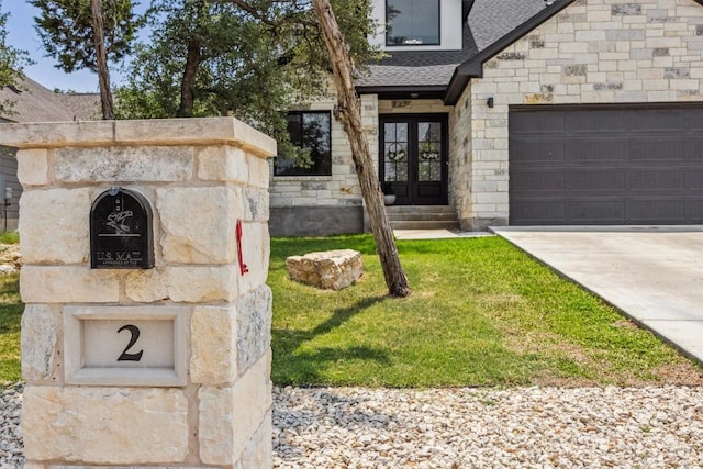 2 Basswood Cir, Wimberley, TX 78676 - entrance to property featuring french doors, roof with shingles, an attached garage, stone siding, and concrete driveway