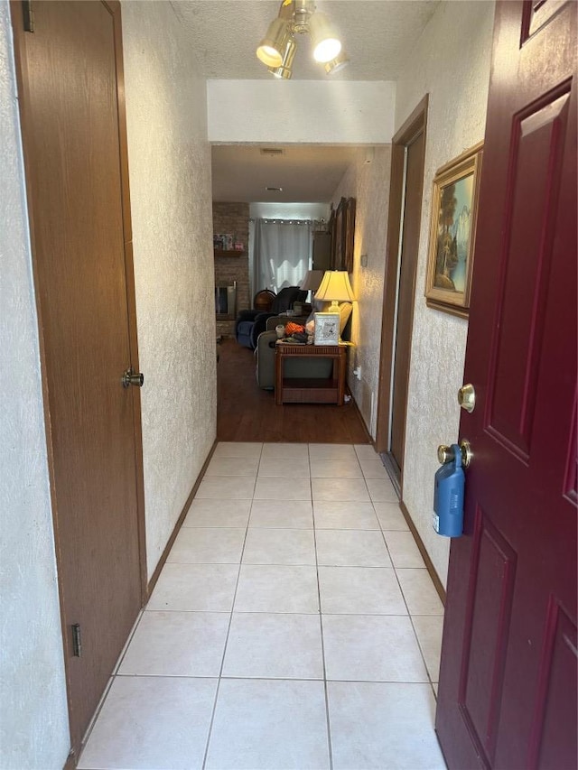 6400 Earlyway Dr, Austin, TX 78749 - hall featuring a textured wall and light tile patterned flooring