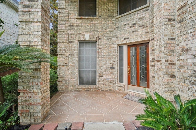 5616 Gorham Glen Ln, Austin, TX 78739 - view of exterior entry featuring a patio and brick siding